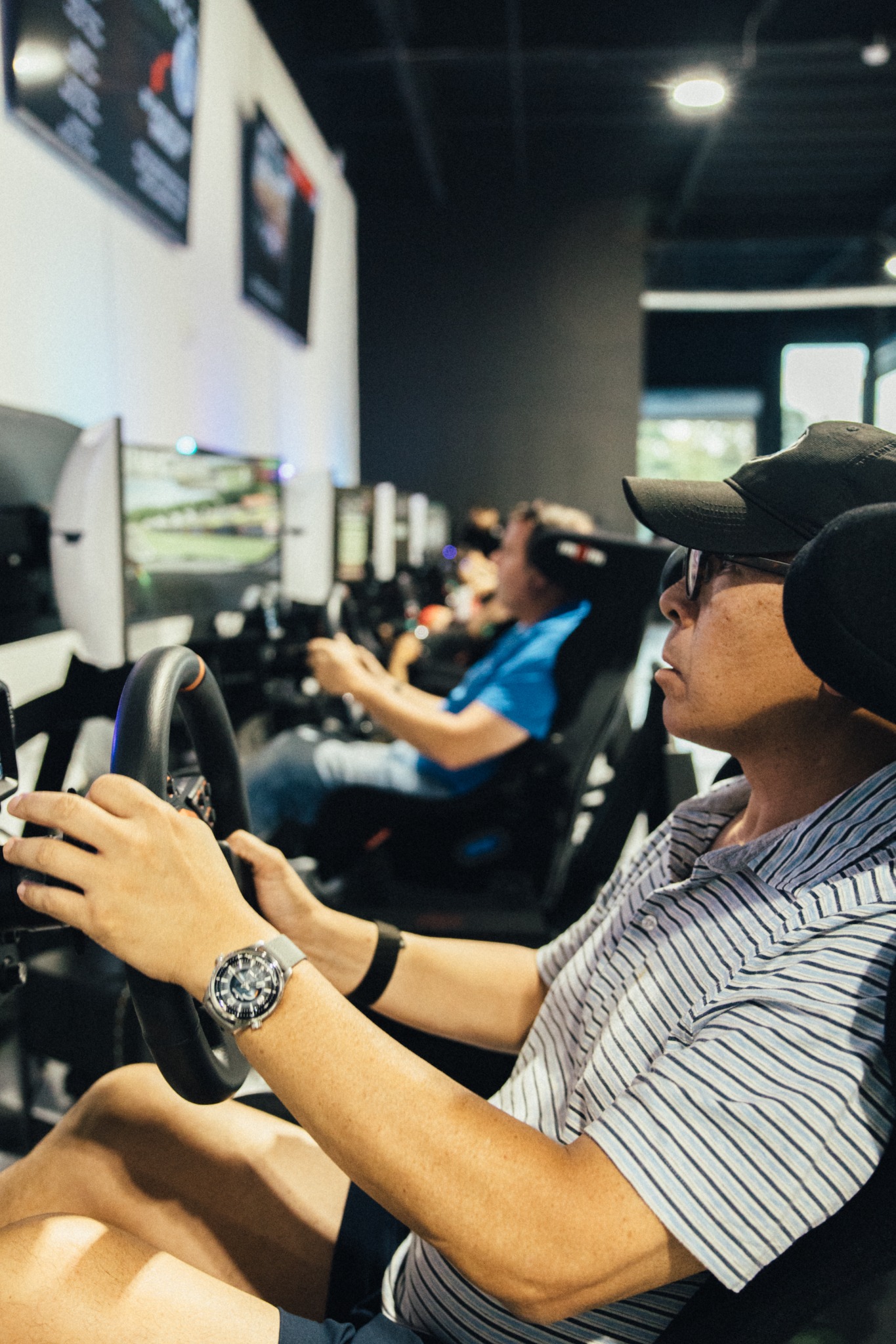 Member driving a simulator in a private room at SIM1 Racing.