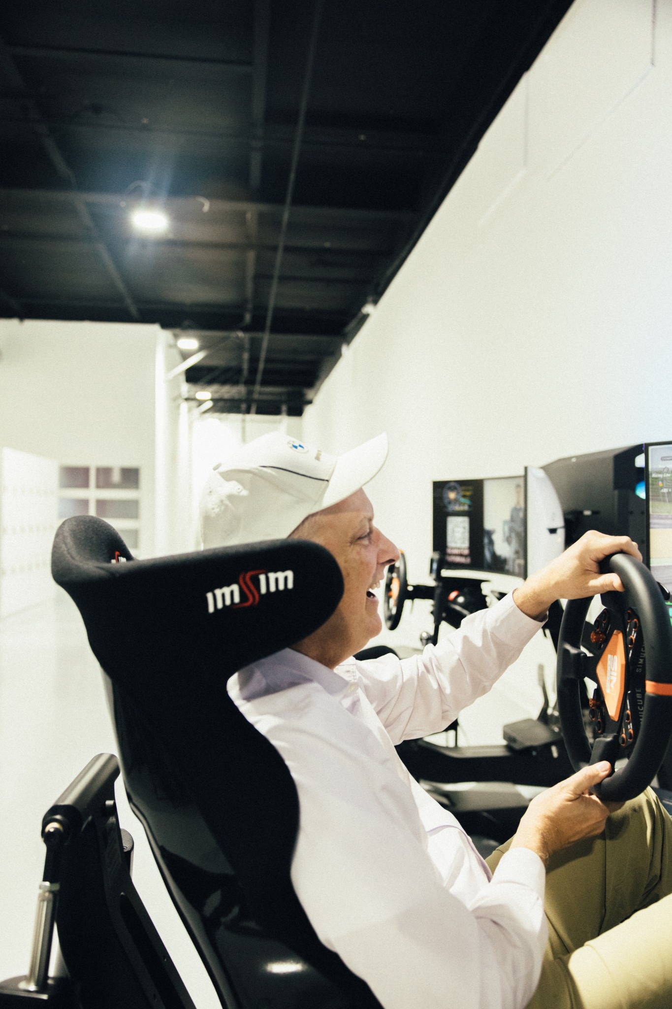 Member driving a simulator at SIM1 Racing.