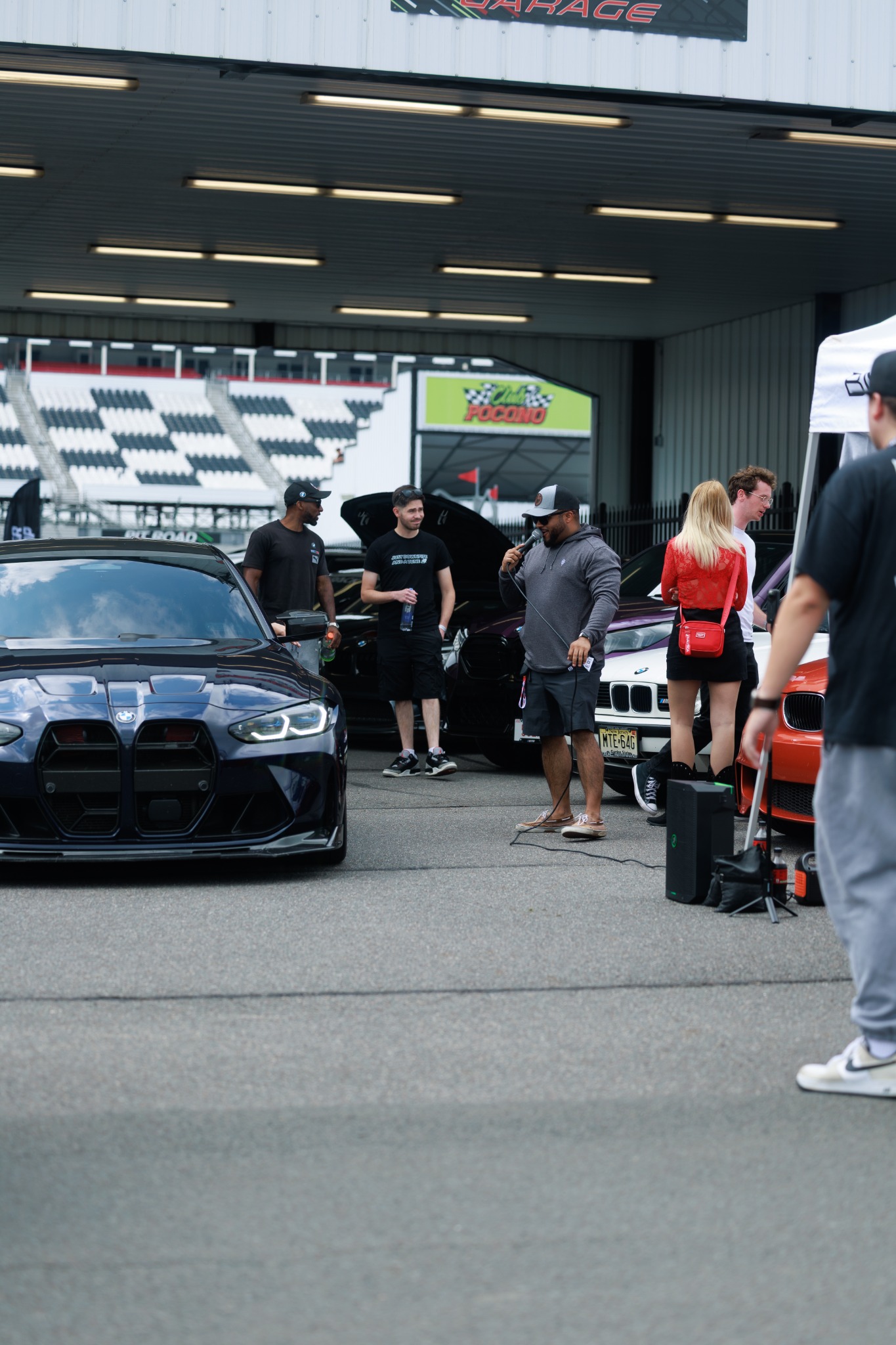 Attendees and BMWs gathered at the MPACT East display area.